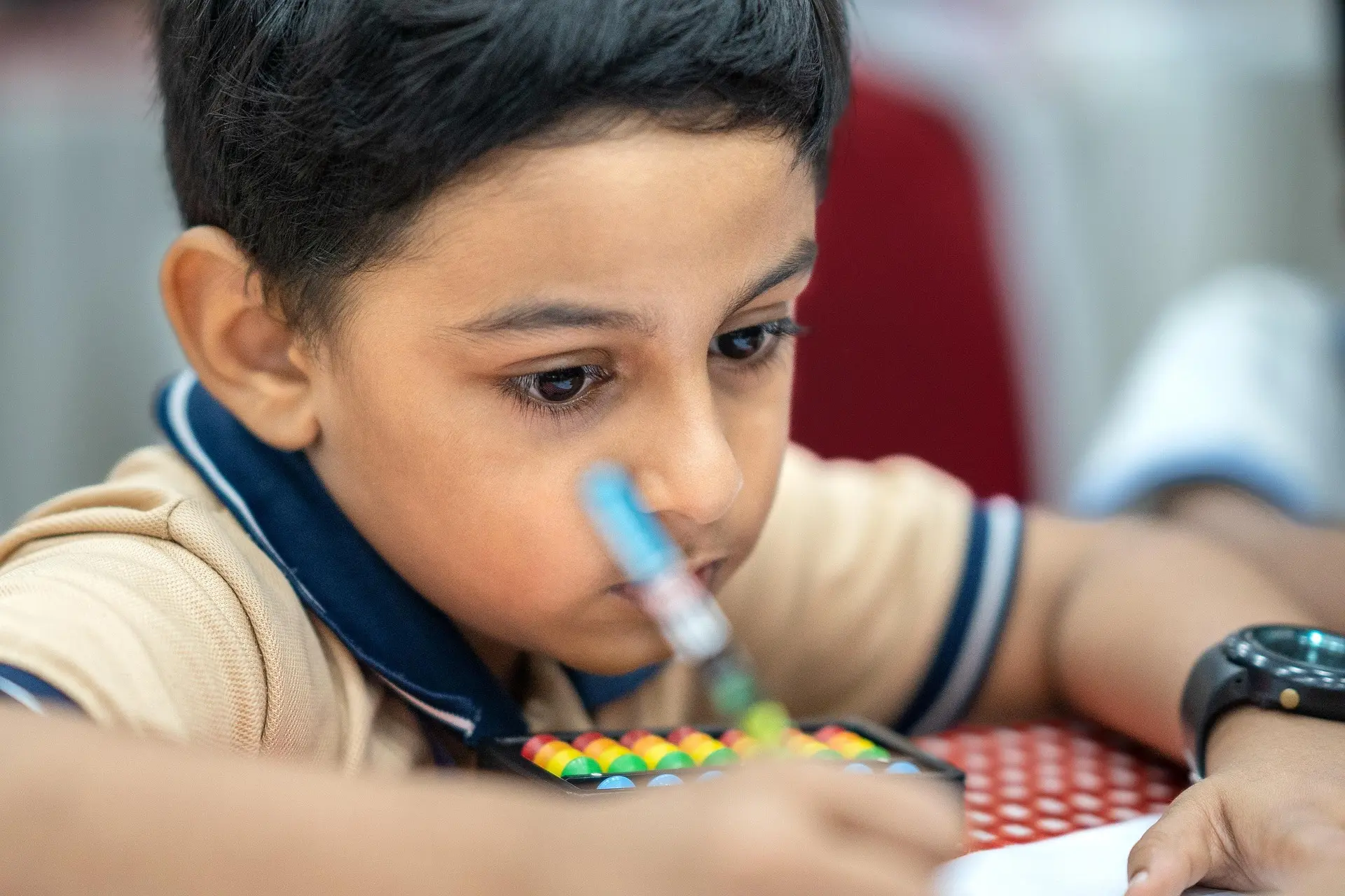 A focused student practicing on an abacus