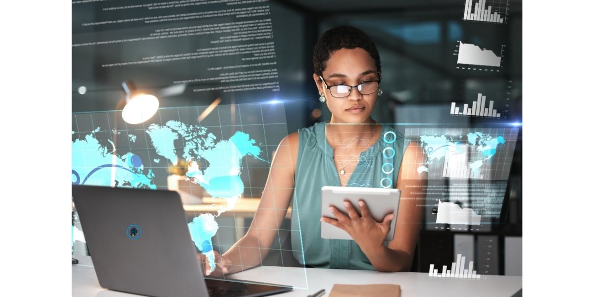 A modern classroom with students collaborating on laptops.