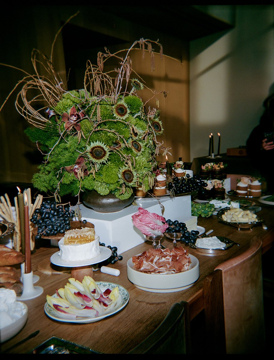A beautifully arranged buffet table features an array of gourmet appetizers, including cheeses, cured meats, and fresh f