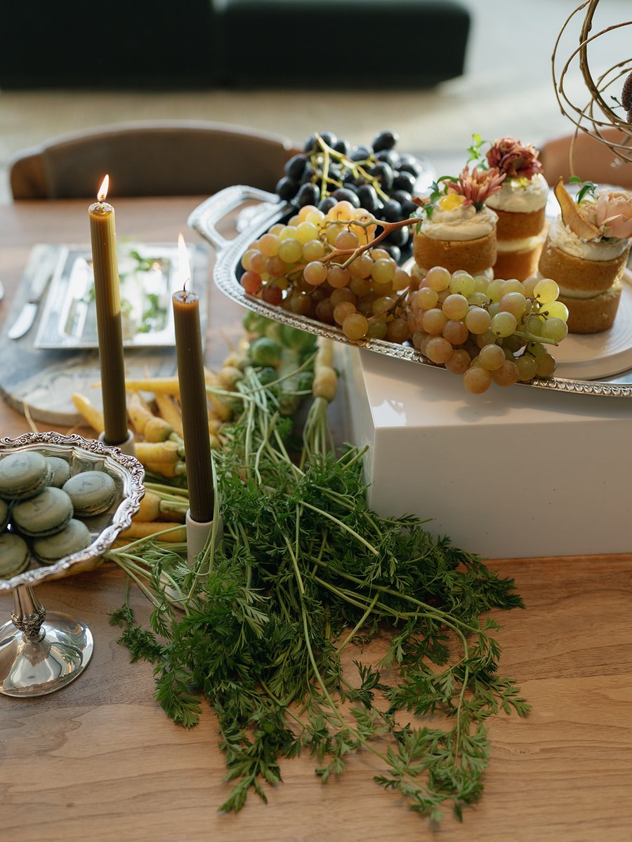 This inviting medium shot showcases a beautifully arranged table setting featuring an assortment of desserts and fresh p