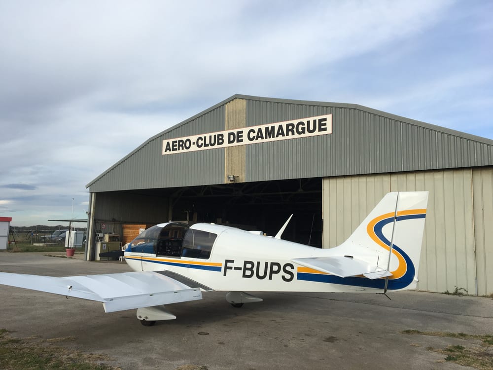 Hangar de l'Aéro-Club de Camargue et un avion sur le tarmac de l'aérodrome de Candillargues.