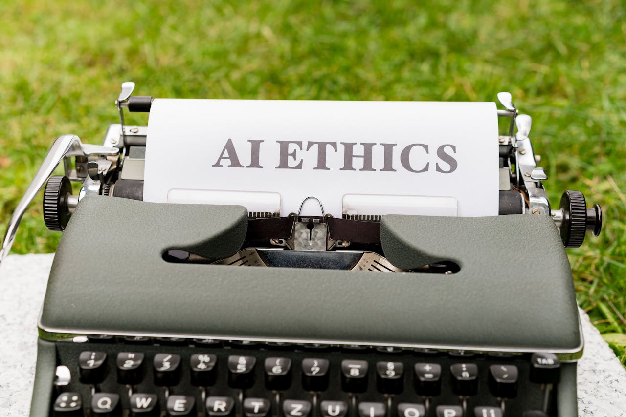 A typewriter with the word "AI ethics" on it. Photo by Markus Winkler on pexels