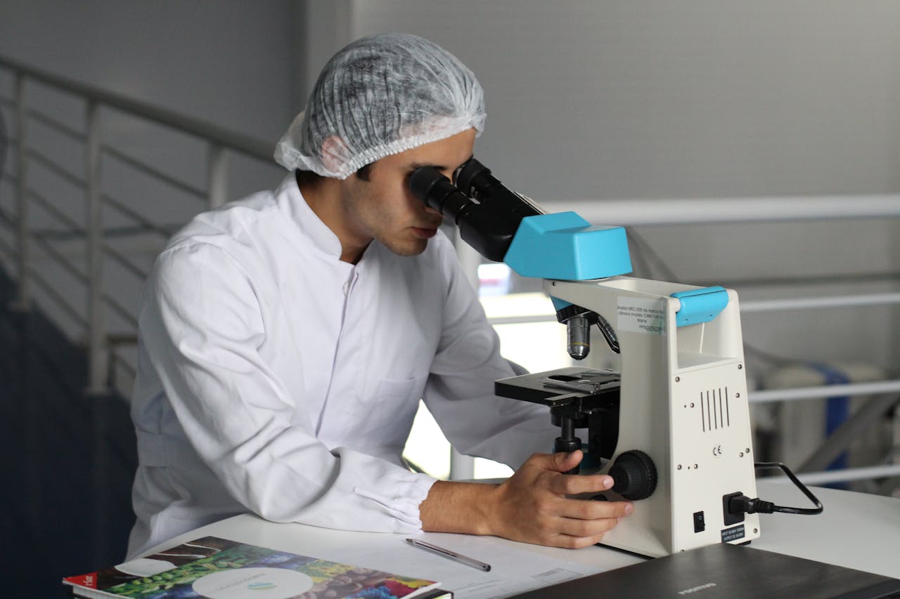 Doctor looking through microscope