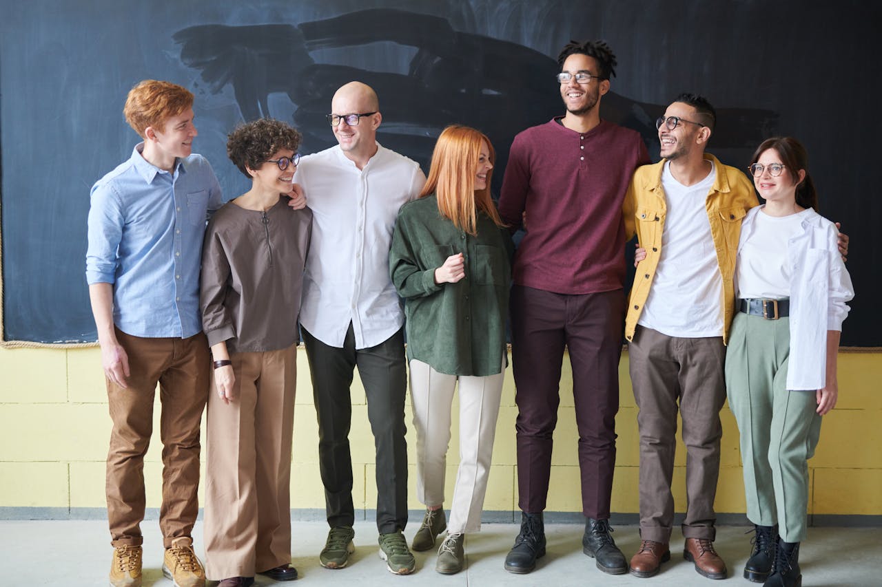 Employees taking a group photo. Photo by fauxels on pexels.com.