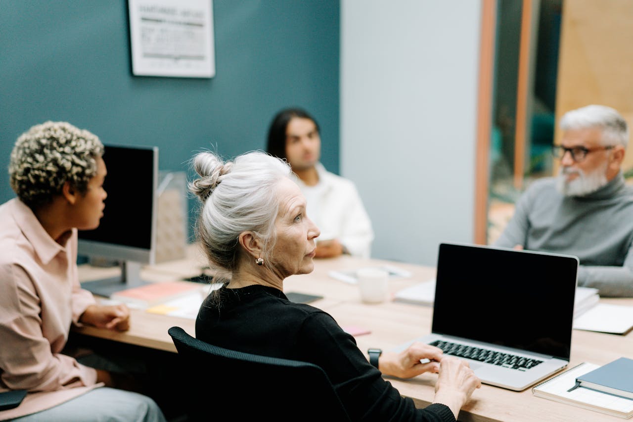 Woman in Black Sweater Sitting on Chair in Front of Macbook Pro. Photo by cottonbro studio on pexels.com.