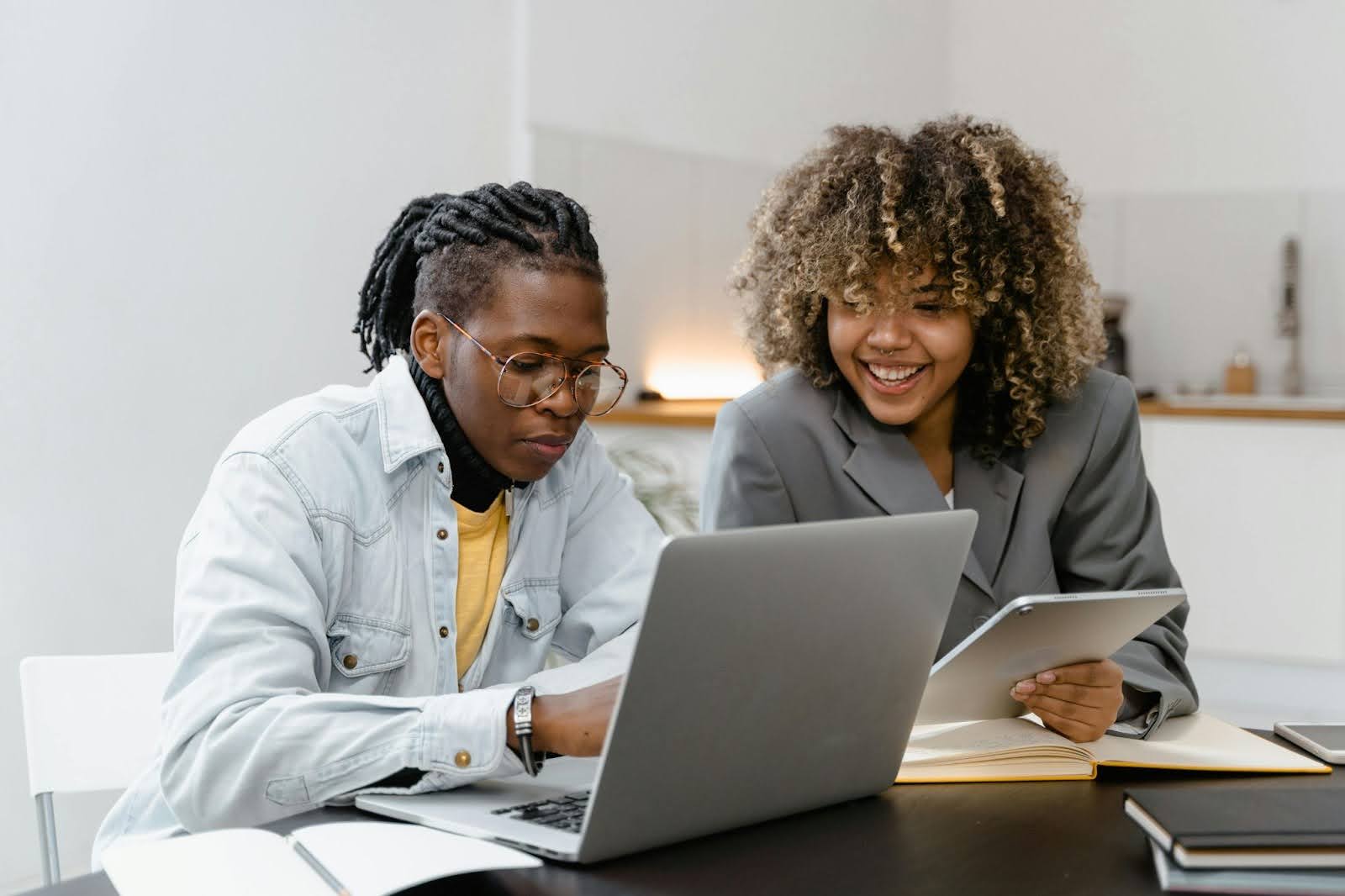 Man and woman behind laptop discussing