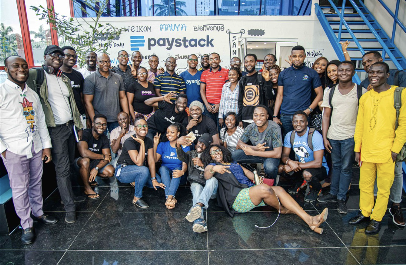 Group of people in front of Paystack banner