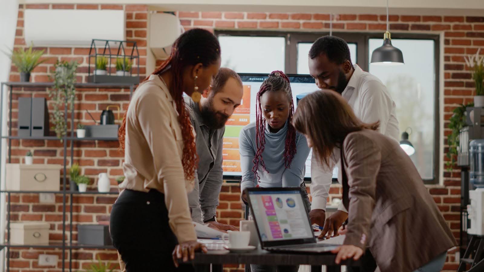 5 people around a work desk