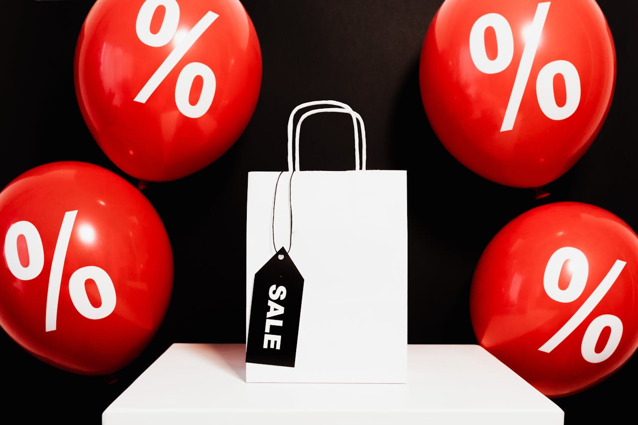 White Paper Bag Surrounded by Red Balloons. Photo By: Kaboompics.com on pexels.com