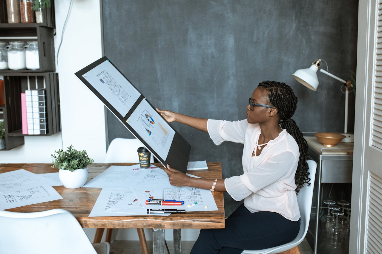 Photo Of Woman Looking At Her Work. Photo by RDNE Stock project on pexels.com