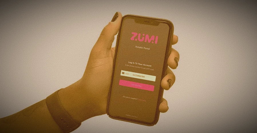 Hand holding phone with Zumi app