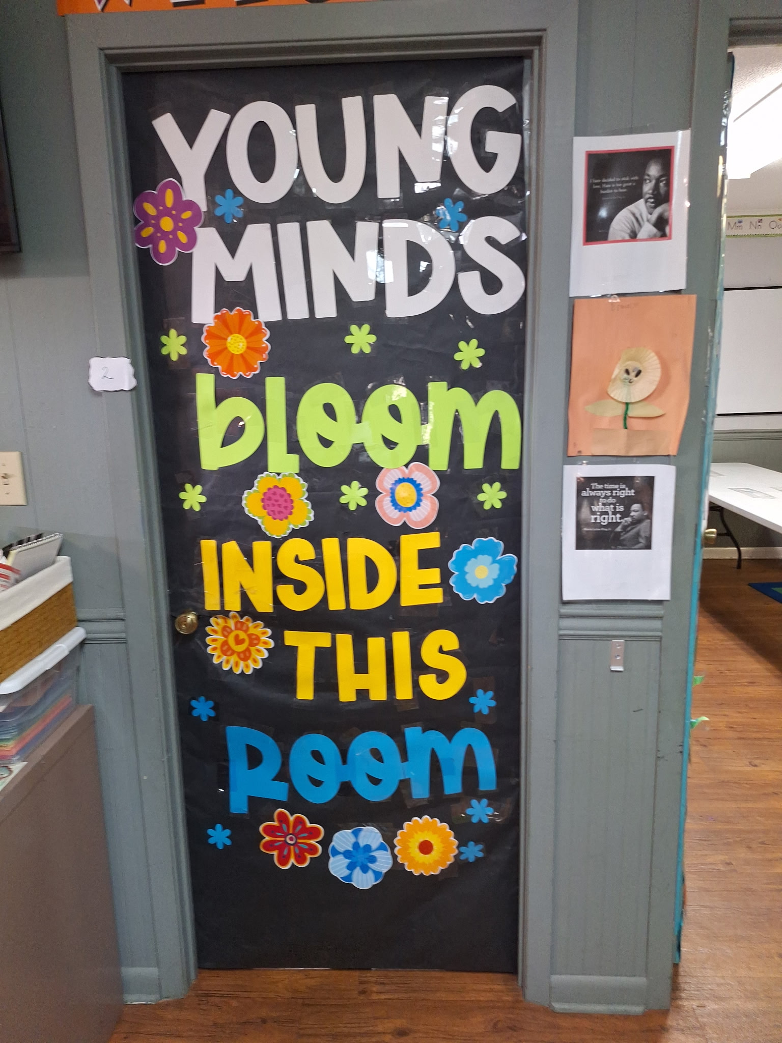 Small group learning room door decorated with flowers and bright lettering