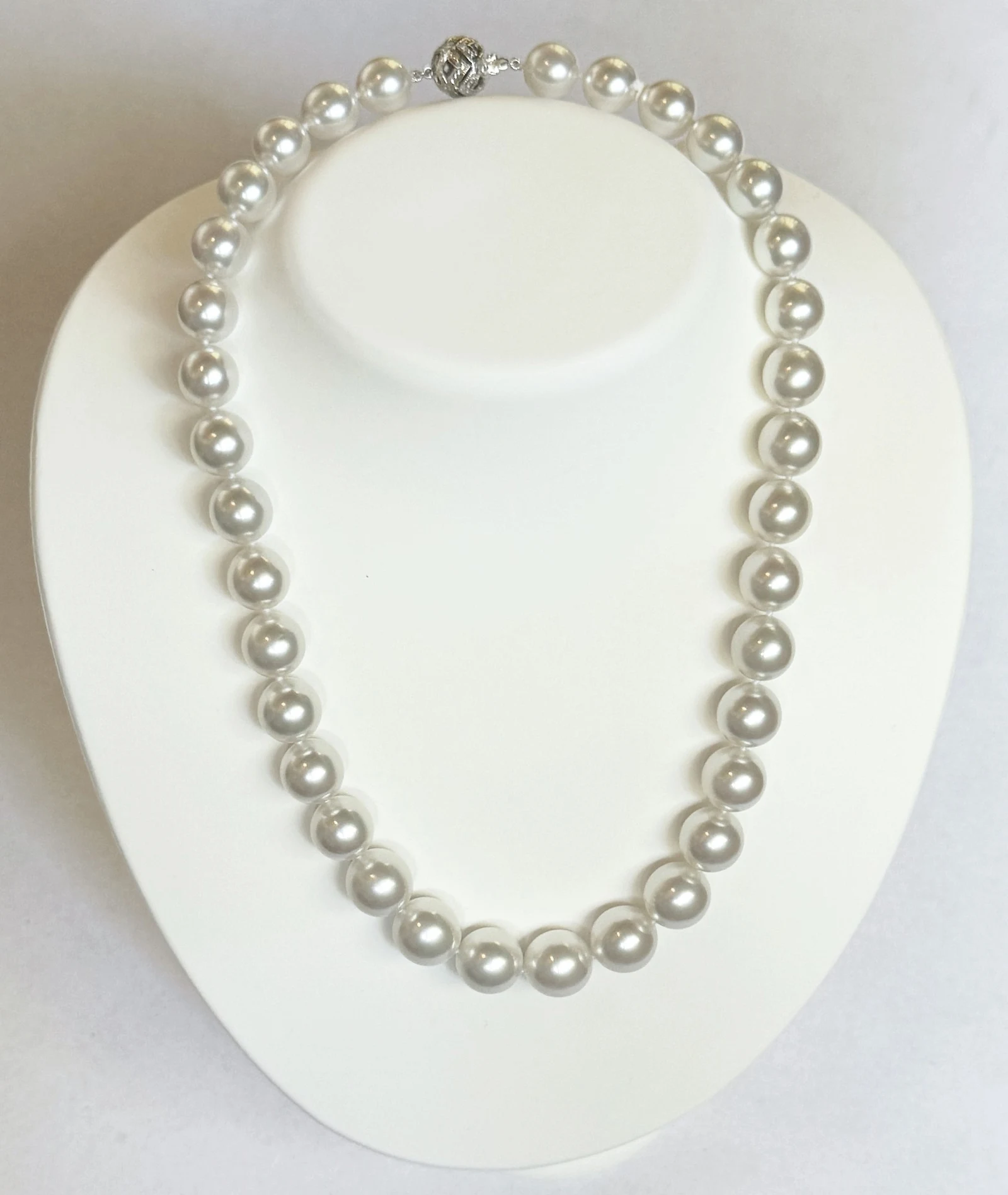 10.1–12.9mm White South Sea Pearl Necklace on a display bust