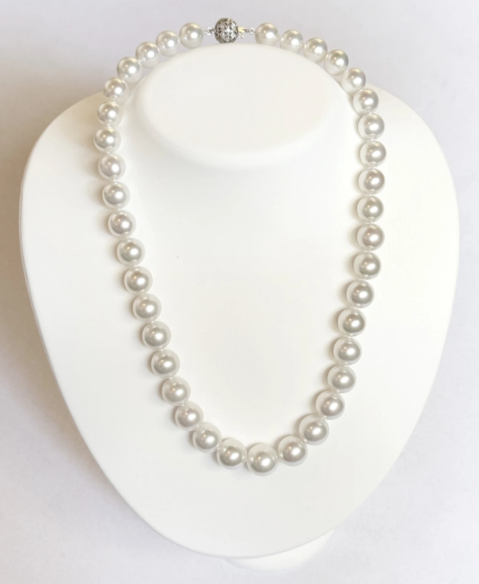 10–12.8mm White South Sea Pearl Necklace on a display bust