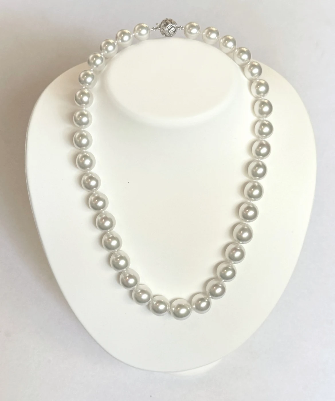 10.2–12.9mm White South Sea Pearl Necklace on a display bust