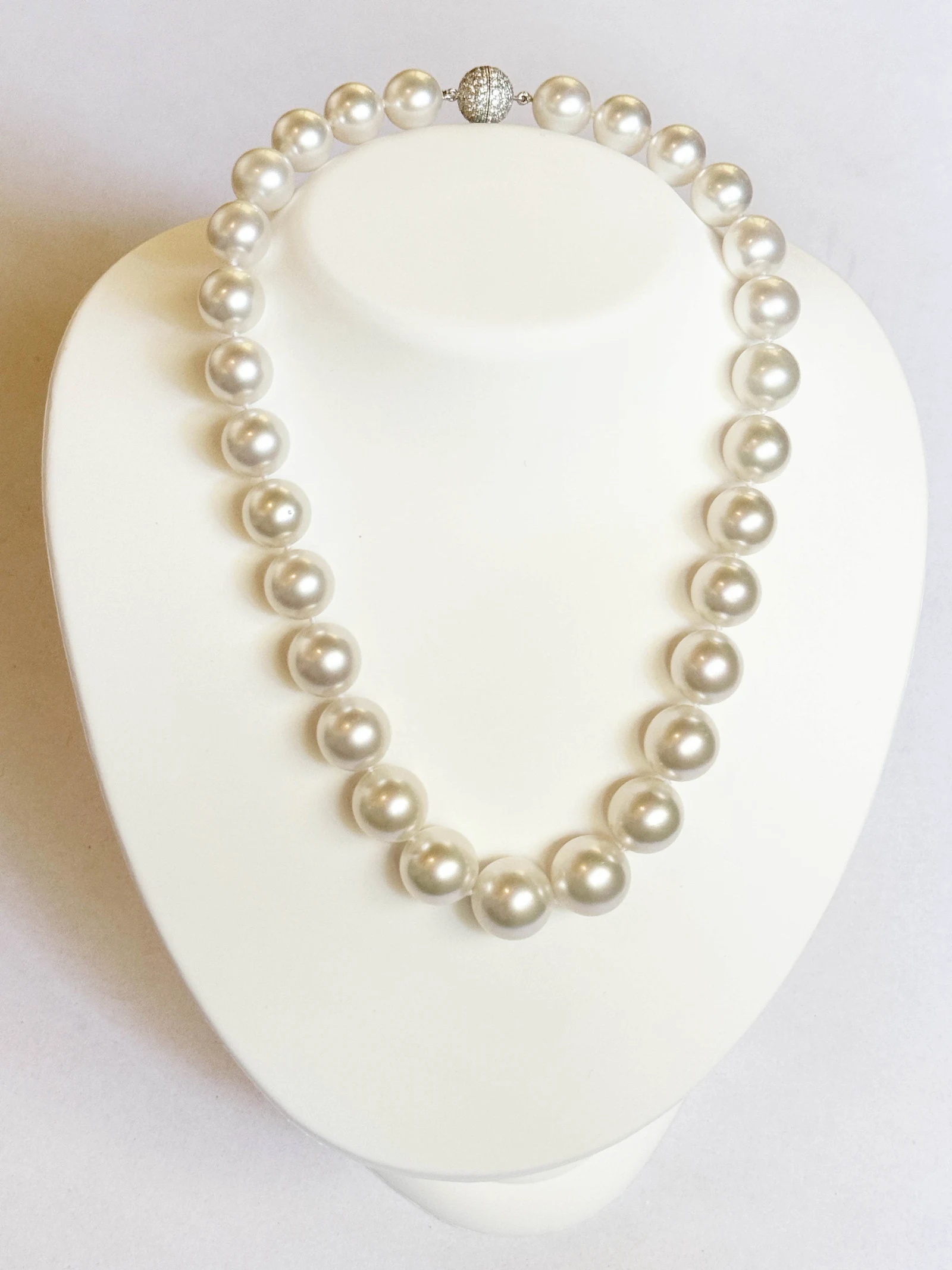 12–15.9mm White South Sea Pearl Necklace on a display bust