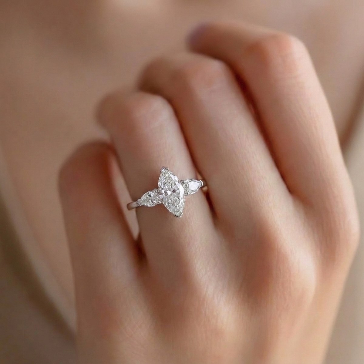 The marquise and pear-cut diamond engagement ring worn on its own in 14K white gold
