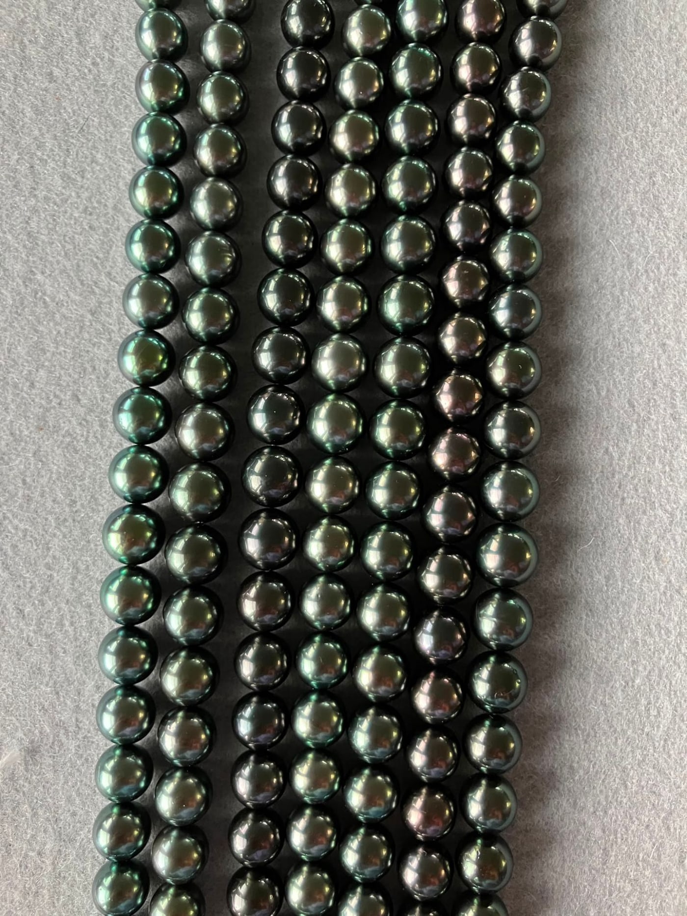 New TRUE AAA Tahitian pearl strands, 8mm to 10mm, laid side by side: dark black, black-green and peacock