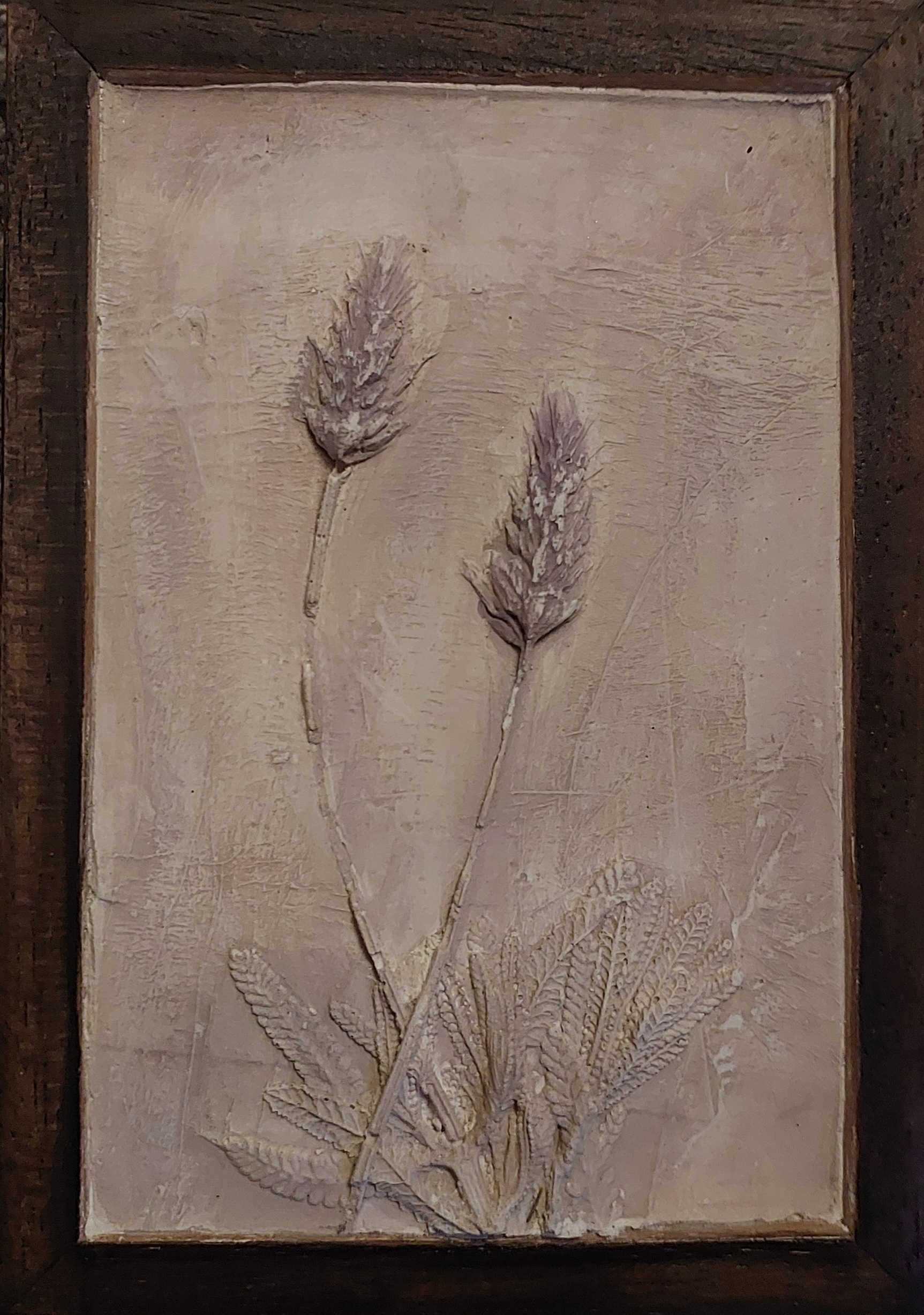 Small handmade botanical bas-relief with three raised flower stems in a rustic upcycled wooden frame, finished with walnut ink.