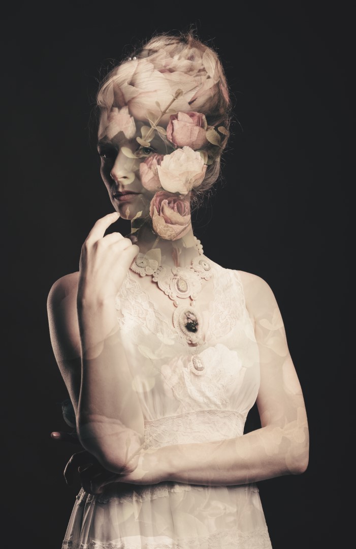 Lady, My Lady surreal art print by Donna O’Donoghue featuring a woman in a vintage lace dress with softly layered roses covering part of her face.
