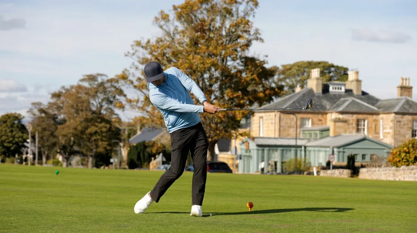 Golfer in a blue shirt swinging a driver