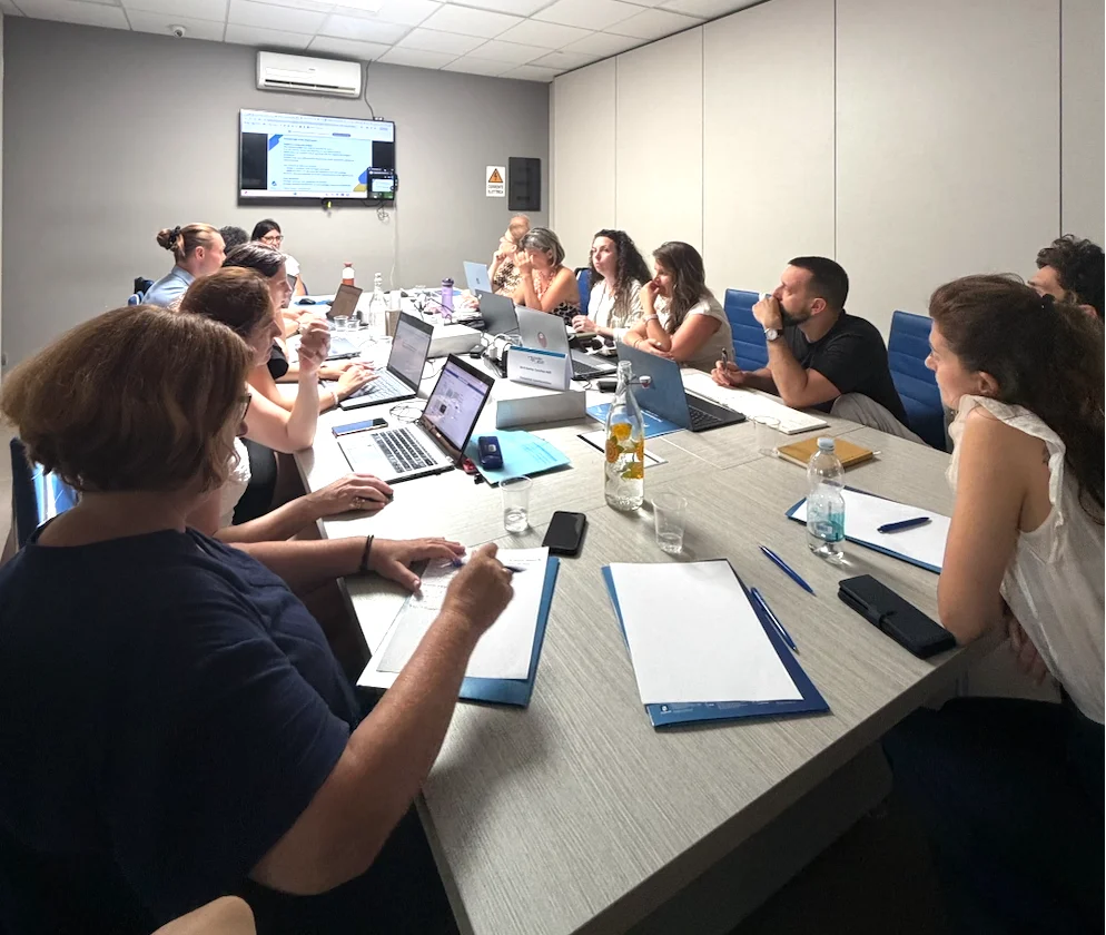 people in the meeting room looking at the screen