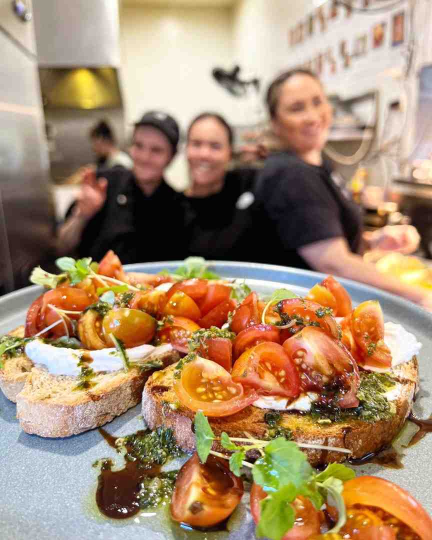 A delicious, artisanal tomato bruschetta with pesto and balsamic on toast, prepared by a highly experienced, smiling team. Visit one of the Sunshine Coast best cafes for quality food.