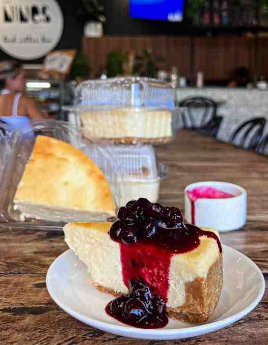 Freshly plated blueberry cheesecake served alongside Cheesecake in take home packs. Freshly plated blueberry cheesecake served alongside Cheesecake in take home packs.
