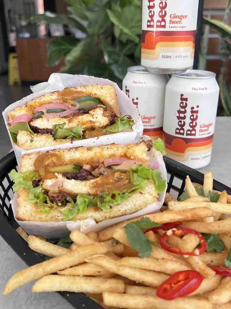 The Nines' Satay chicken sandos served with crispy chips and Better Beer Ginger Beer highlighting the flavourful offerings of coffee and bar Maroochydore. The Nines' Satay chicken sandos served with crispy chips and Better Beer Ginger Beer highlighting the flavourful offerings of coffee and bar Maroochydore.