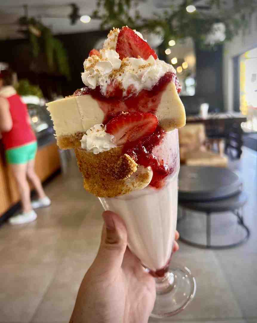 A highly decadent strawberry cheesecake milkshake served in a glass with cream and crumbs. This epic sweet treat is one of the great summer drinks. A highly decadent strawberry cheesecake milkshake served in a glass with cream and crumbs. This epic sweet treat is one of the great summer drinks.