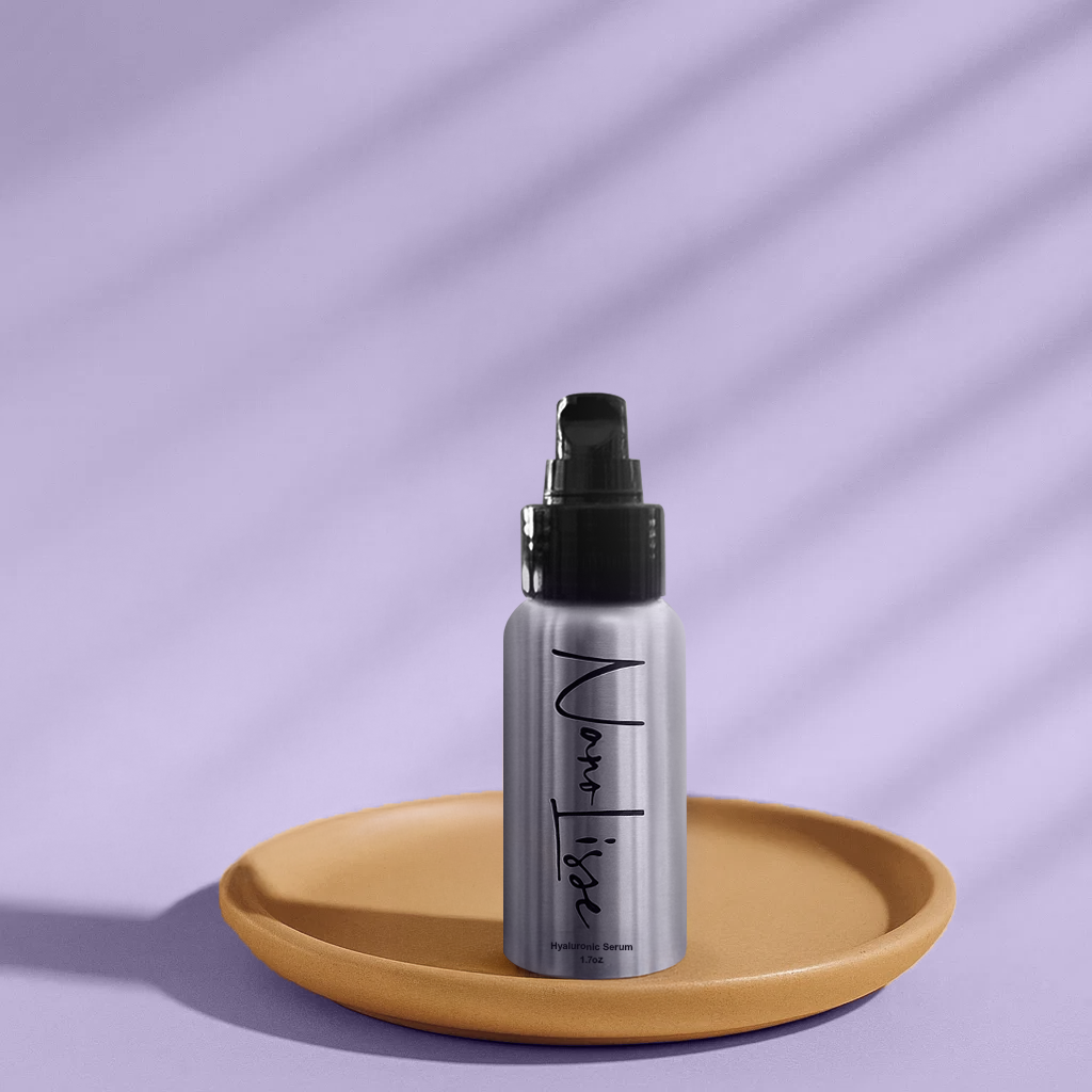 Bottle of NanoLisse Pure Hyaluronic Acid Serum placed on a tan tray against a soft lavender background, emphasizing modern minimalist skincare design.