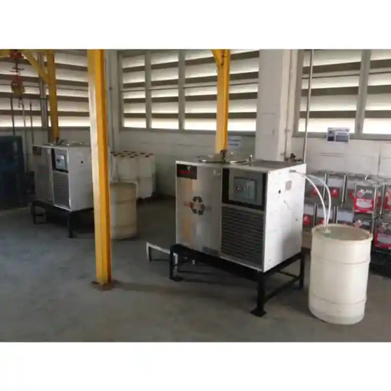 commercial automated solvent distillation machine set up in a refinishing facility