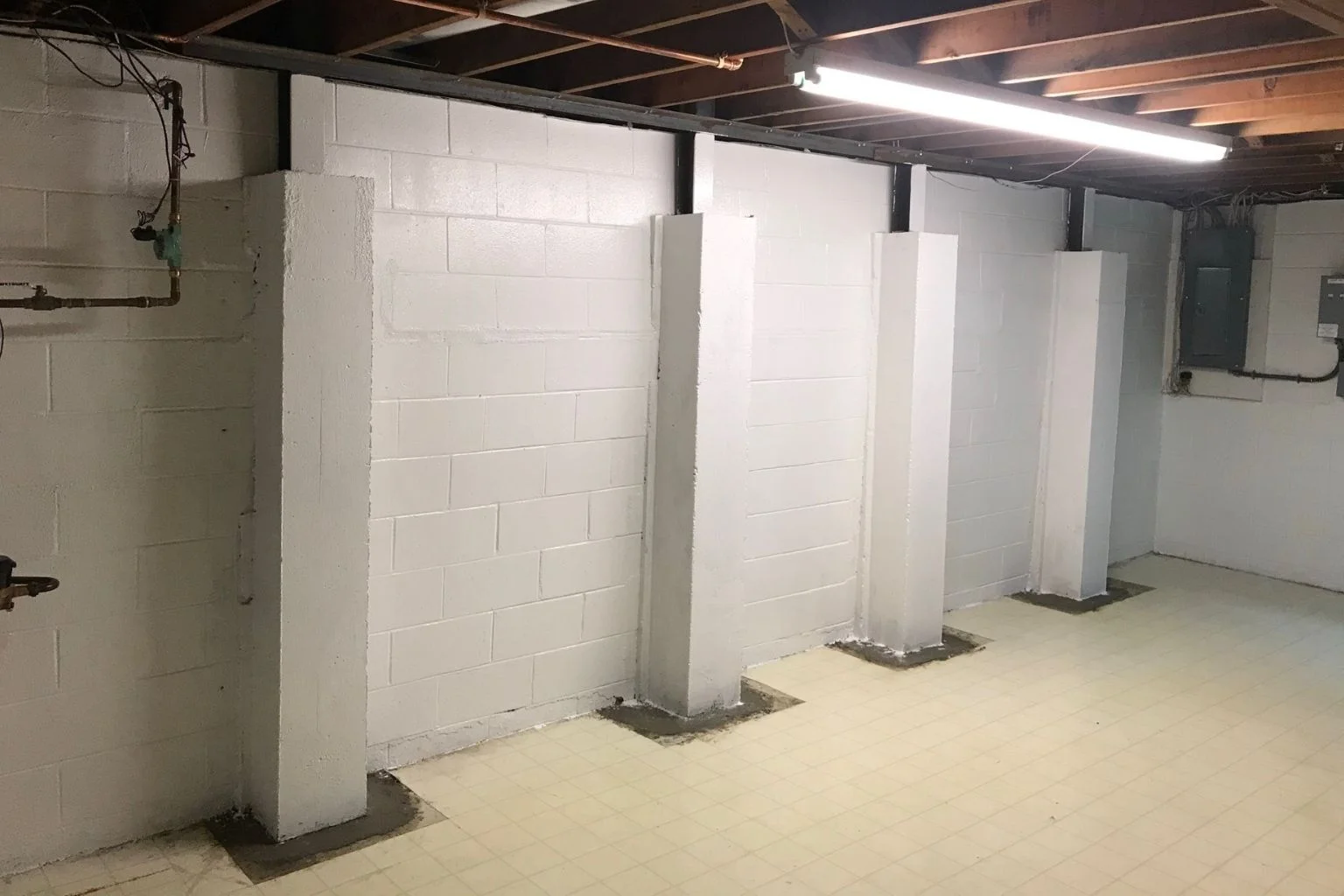 Reinforced basement foundation wall with horizontal crack, indicating potential structural issues.