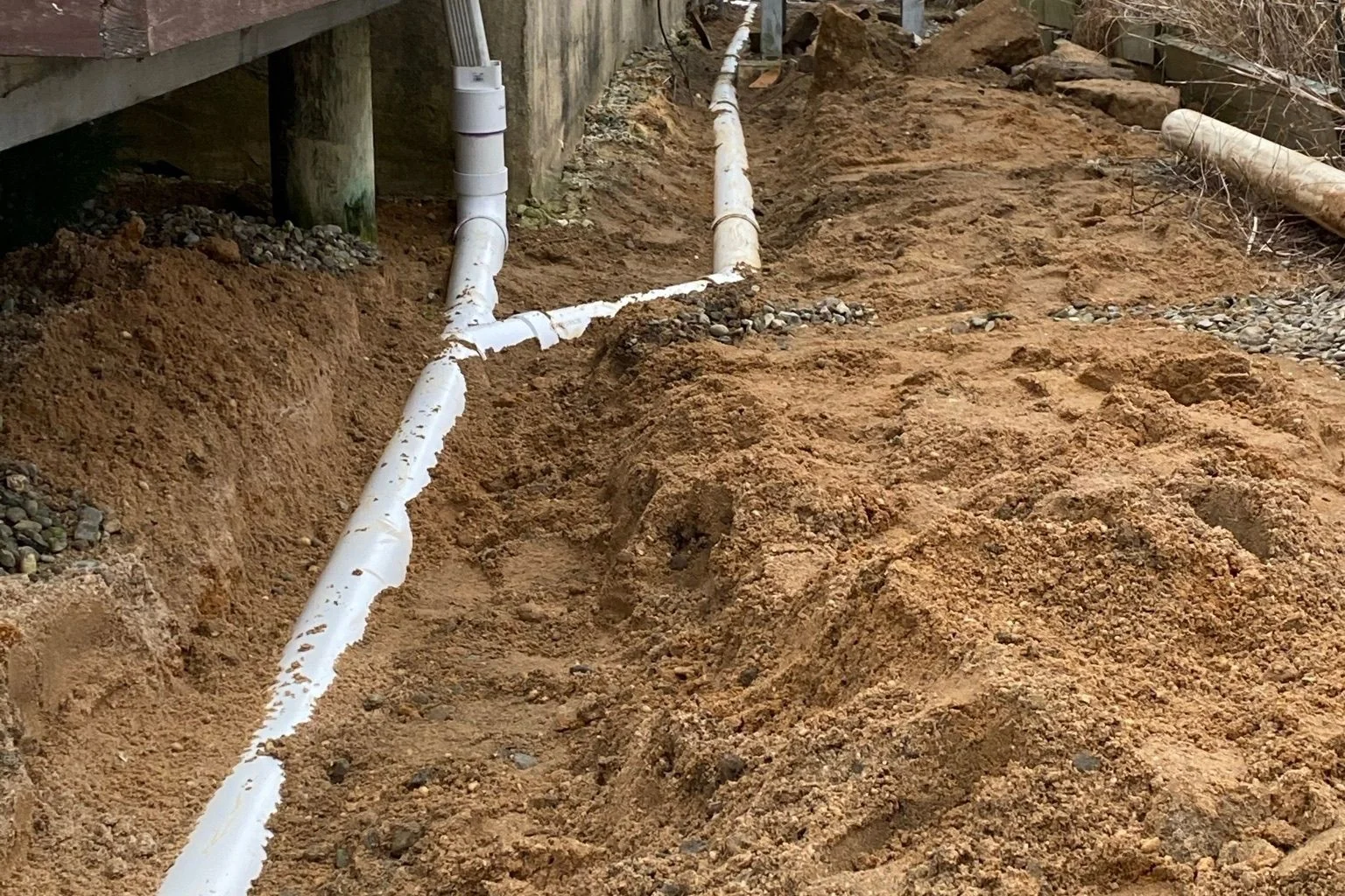 user-inserted Exterior French drain pipe installation for New Jersey homes.