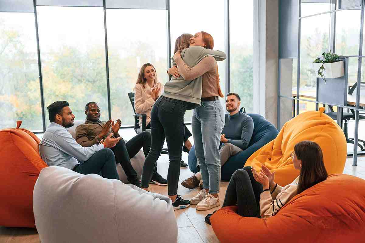 A group therapy session in progress with several individuals actively participating - inpatient detox program