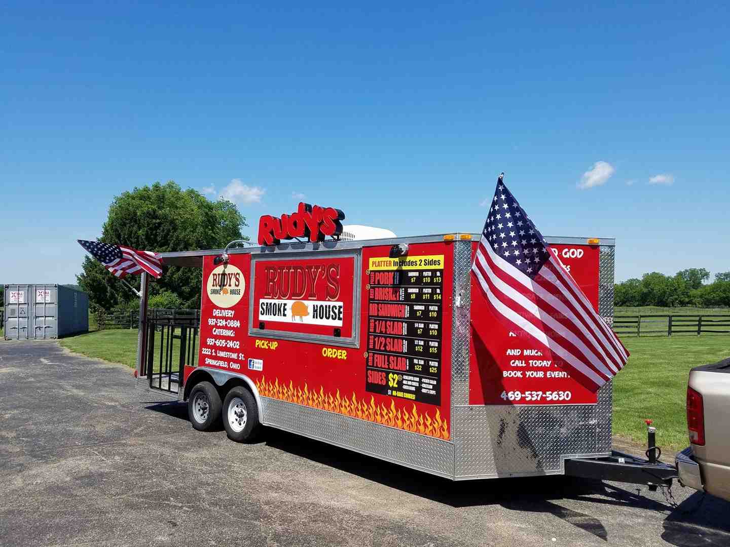 The Rudy's Smokehouse food truck serving happy customers at an outdoor festival. - Catering Springfield