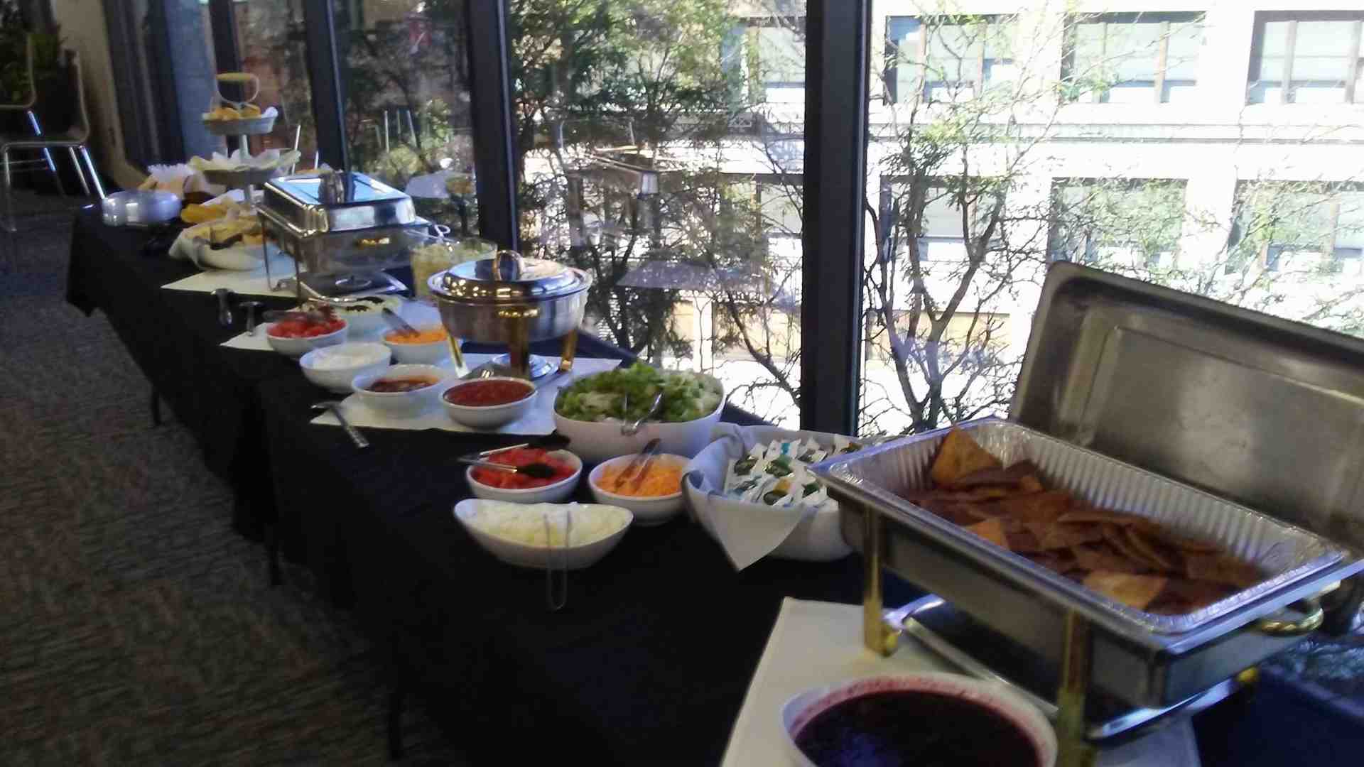 Rudy's Smokehouse team serving BBQ at catering event Rudy's Smokehouse team serving BBQ at catering event