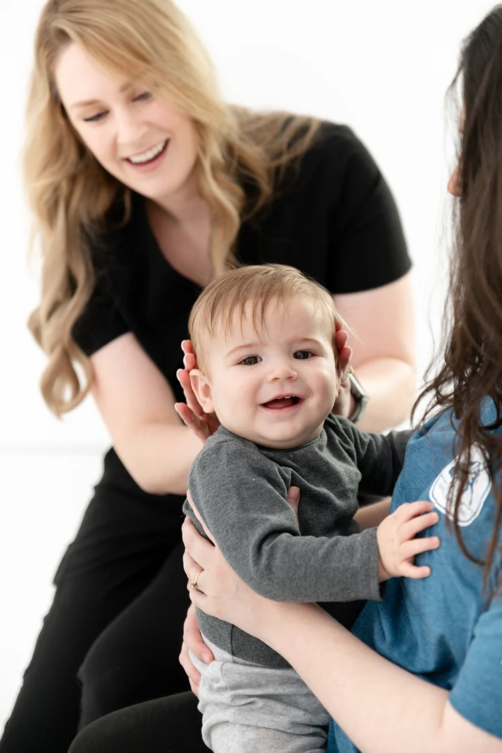 mother using nursing pillow and footrest to keep baby at breast height with neutral spine