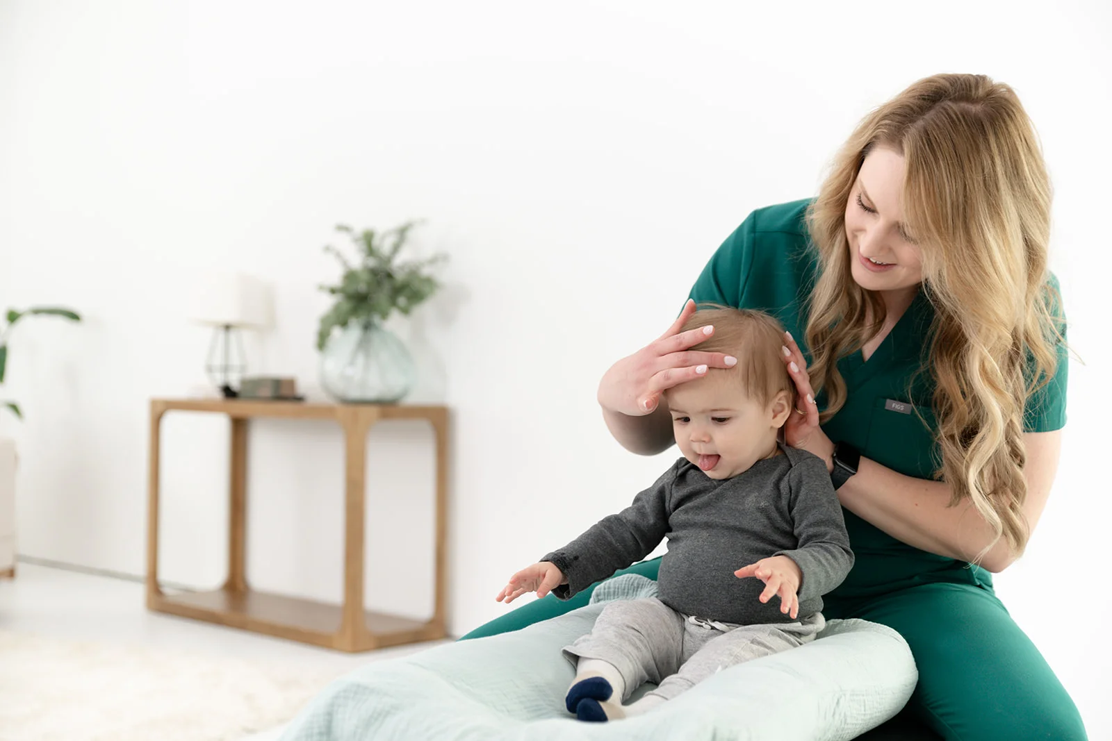Infant engaging in supervised tummy time play on a soft mat