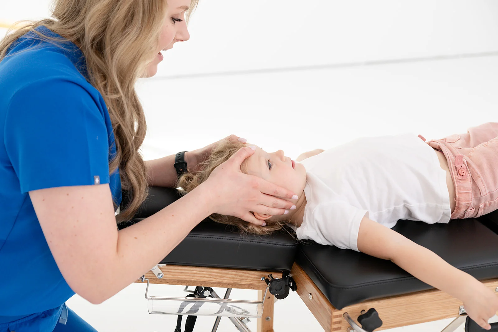 chiropractor assessing spinal alignment in a young athlete