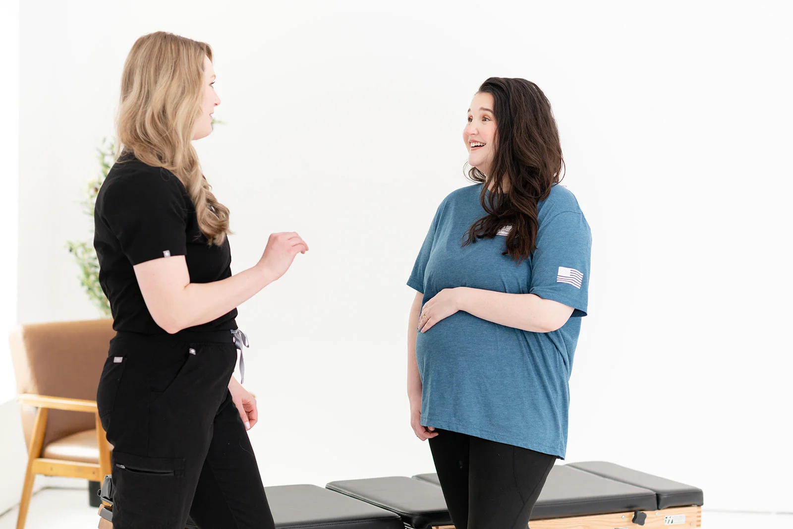 woman performing a gentle prenatal stretch in a calm studio environment
