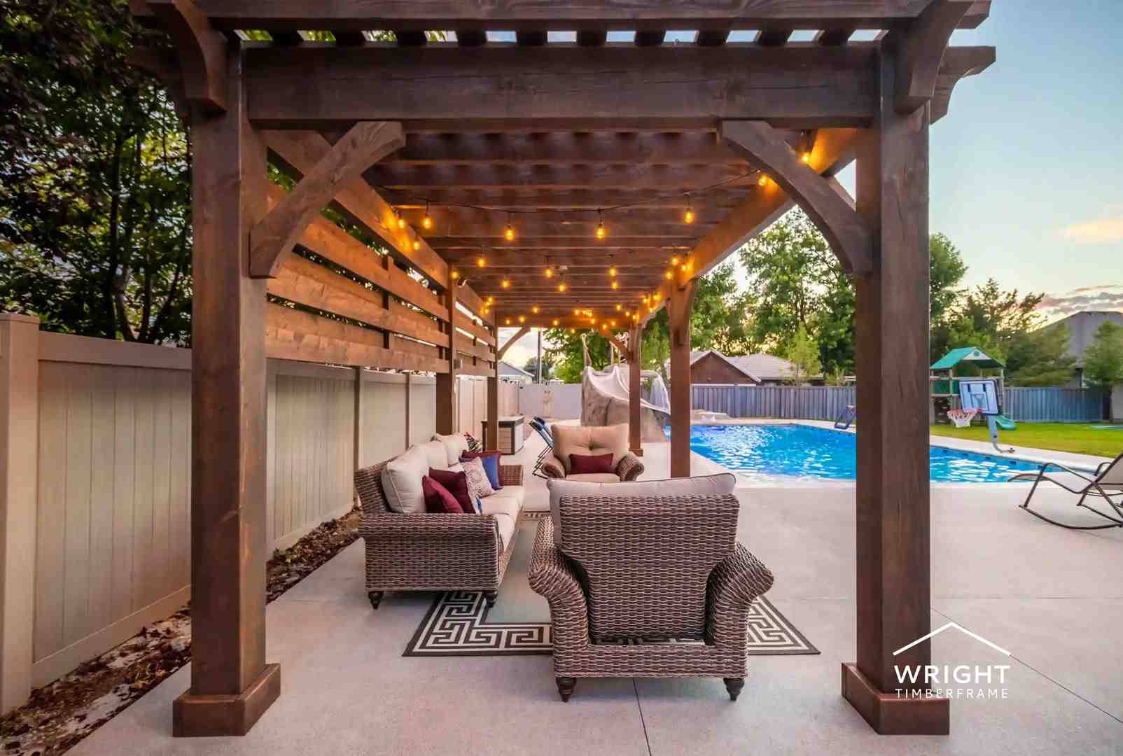 Backyard Wood Pergola Design with Poolside Seating Wood pergola design with heavy timber posts, string lighting, and outdoor seating beside a backyard pool for evening entertaining.