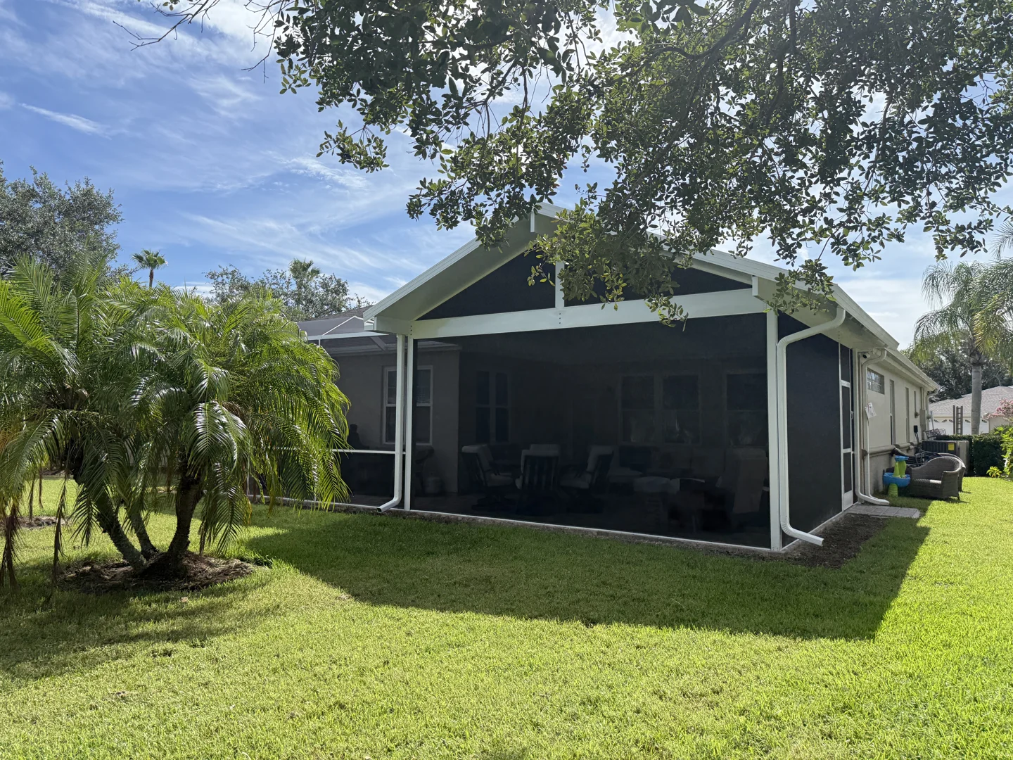classic gable roof patio extension attached to a traditional brick home - patio roof ideas attached to house