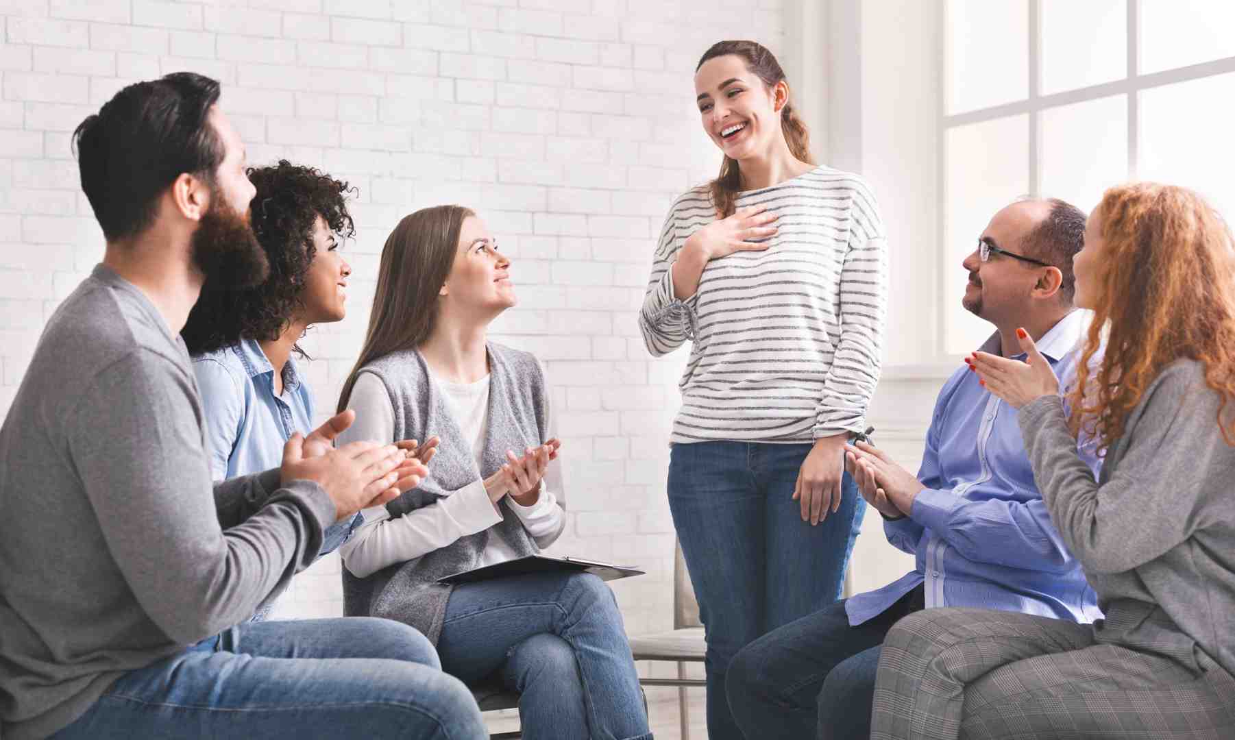 A diverse group of individuals participating in a supportive group therapy session, engaged in discussion and offering encouragement to one another. - drug treatment centers in tennessee