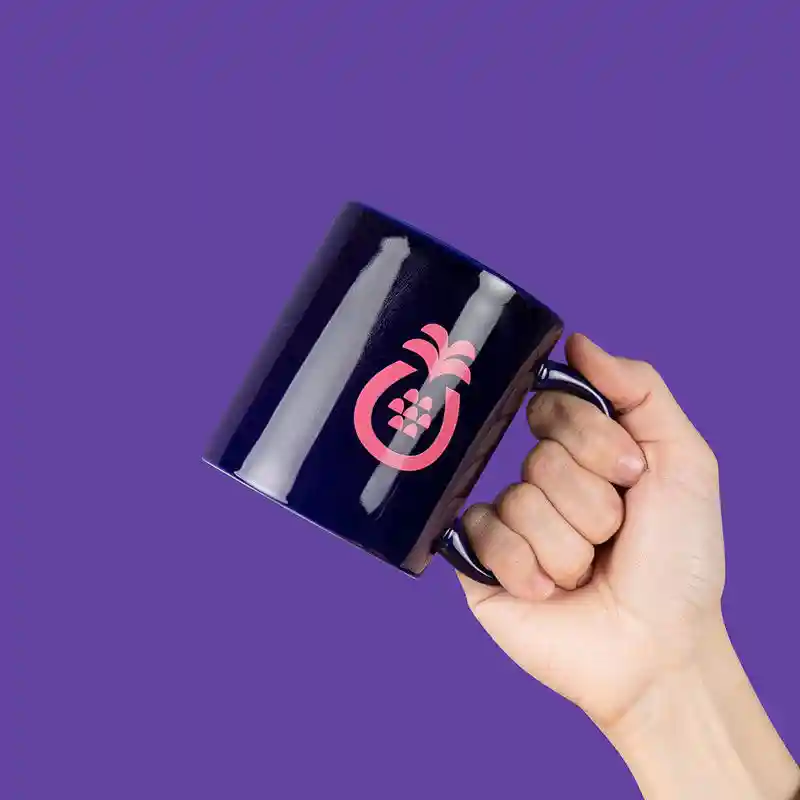 A person happily unboxing a custom merch pack, revealing branded items like a reusable coffee cup, a notebook, and a pen. - loyalty program merchandise