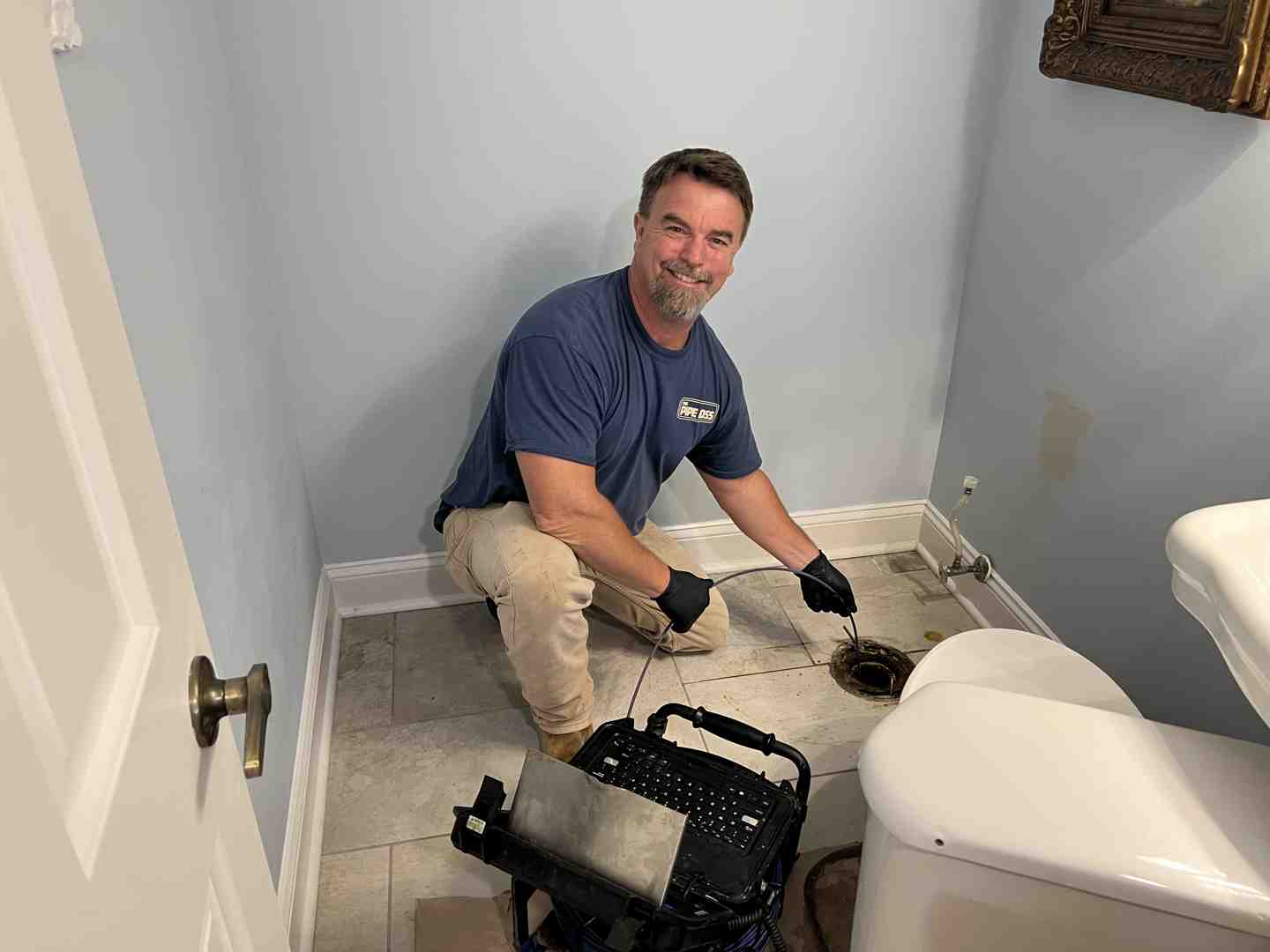 plumber using a camera inspection tool - sewer line back up