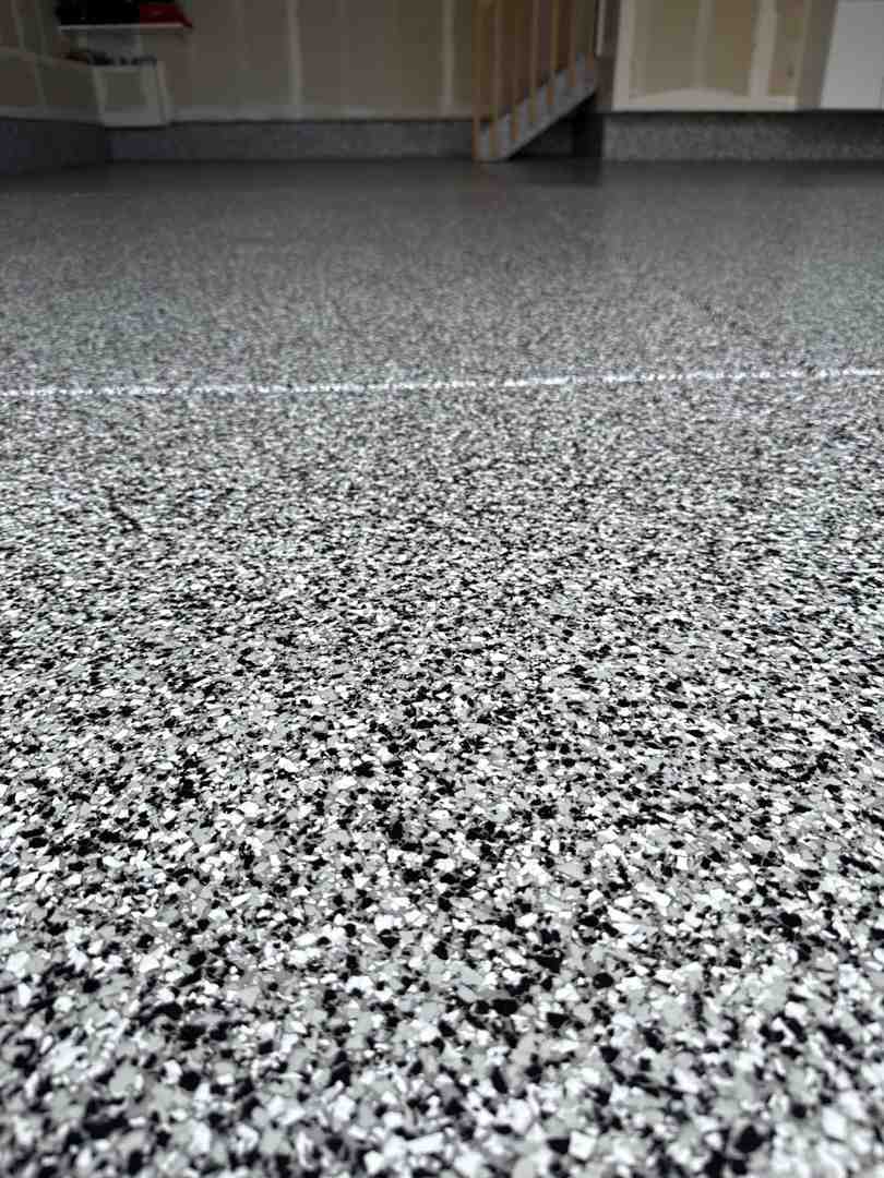 A spacious commercial showroom in Denver featuring a glossy, durable polyaspartic flake floor. A spacious commercial showroom in Denver featuring a glossy, durable polyaspartic flake floor.