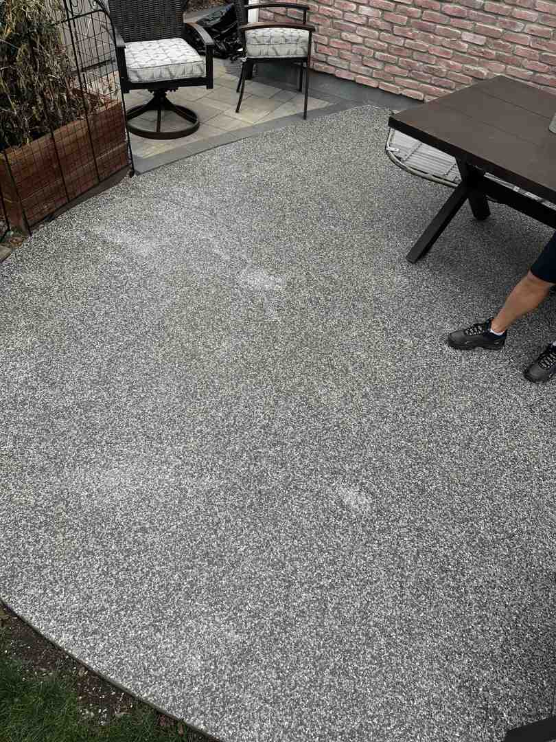 Galaxy technician broadcasting decorative flakes onto a freshly applied basecoat - Concrete restoration Denver