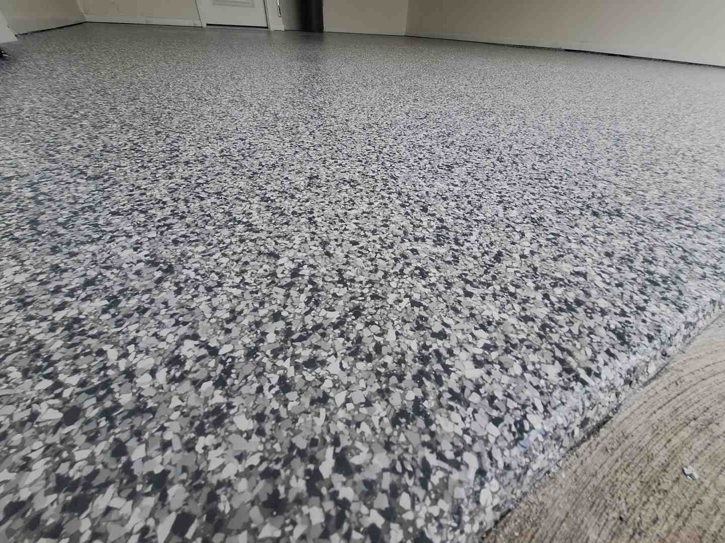 Finished garage floor with Flake/Chip system, demonstrating high-gloss, durable, and decorative finish. - Concrete floor solutions Finished garage floor with Flake/Chip system, demonstrating high-gloss, durable, and decorative finish. - Concrete floor solutions