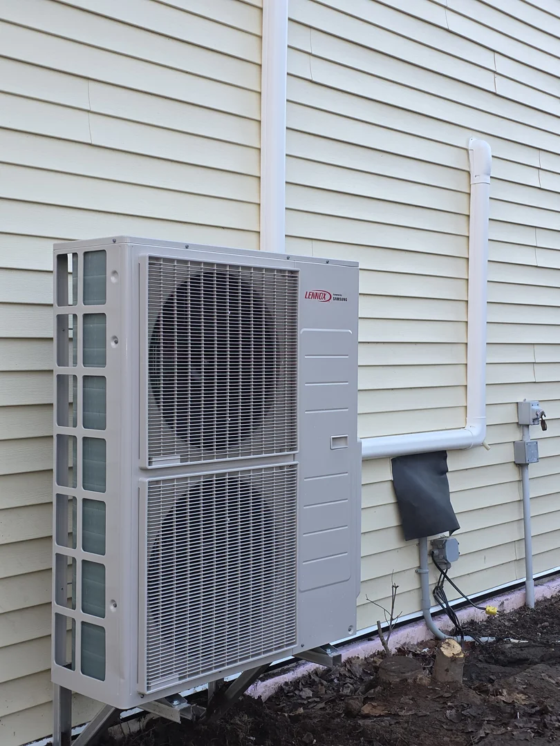 modern central heat pump outdoor unit beside suburban home - central heat pump maintenance burnside ns